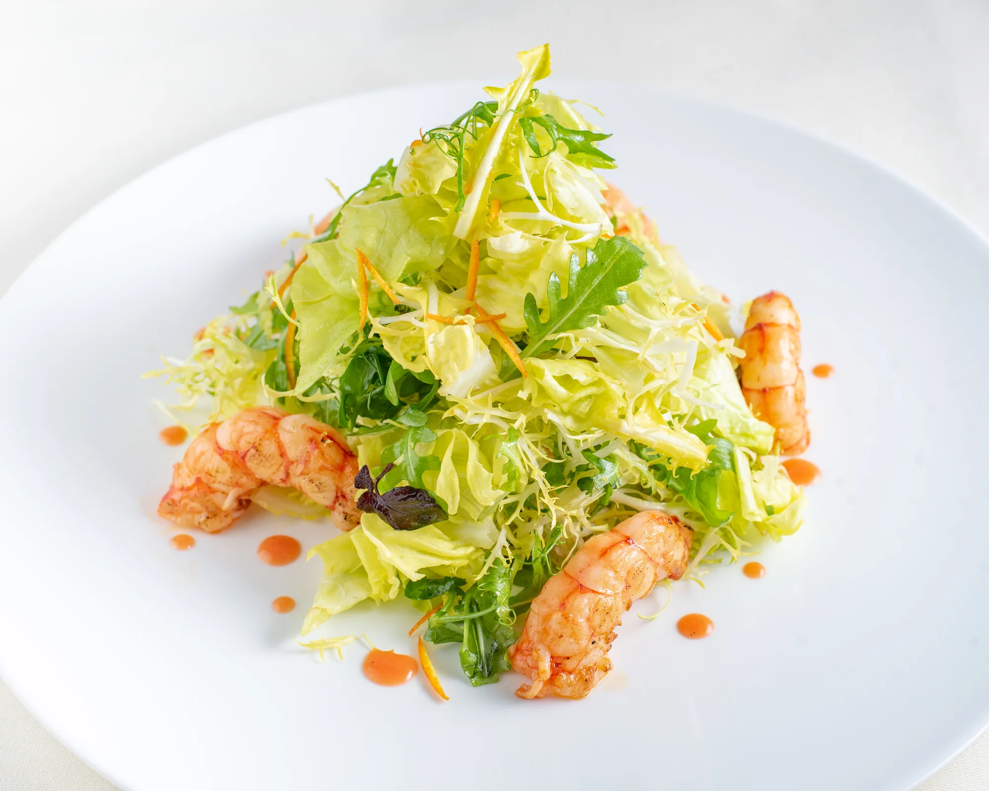 A plated dish topped with fresh greens